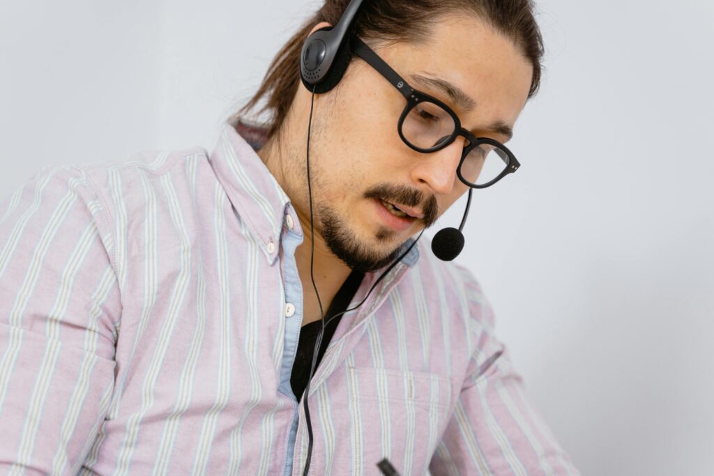 Focused call center agent with headset providing customer support.